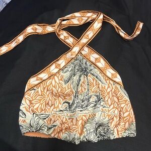 backless pants suit silk,pants are high waisted .The print has  leaves & trees.